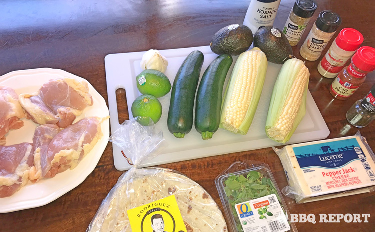 Fresh ingredients for grilled chicken and veggie quesadillas laid out on cutting board