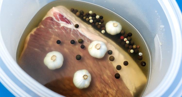 Beef brisket curing in pickling brine with spices