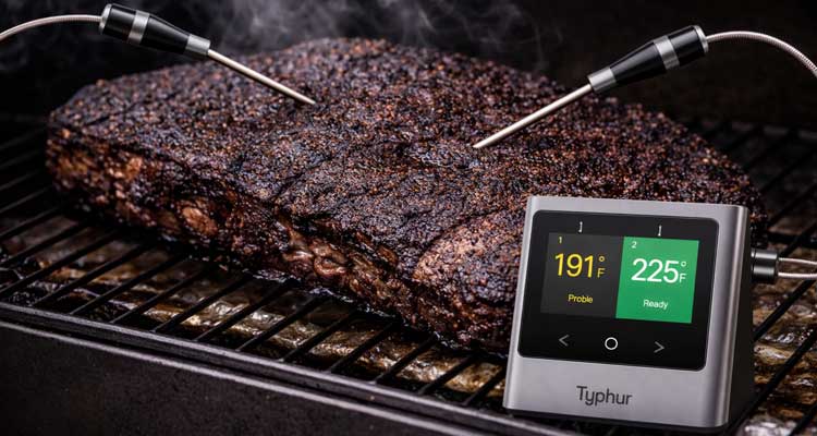 Digital thermometer probes monitoring brisket internal temperature