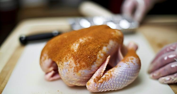 Preparing whole chicken for pellet grill with dry brine seasoning
