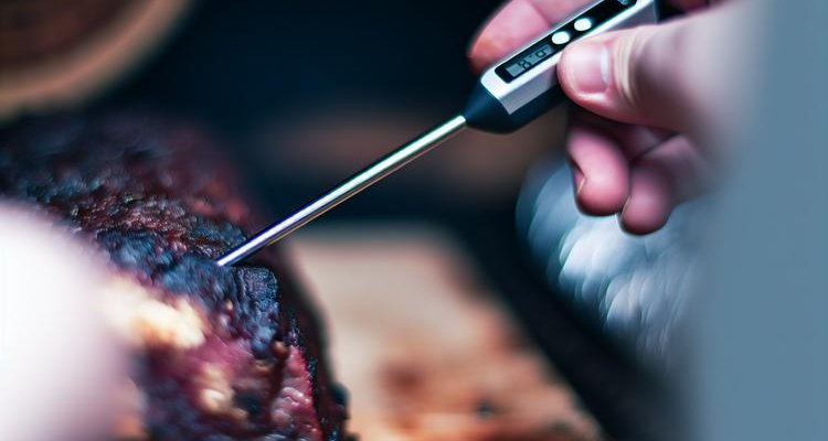 Metal probe entering beef short rib showing tenderness test