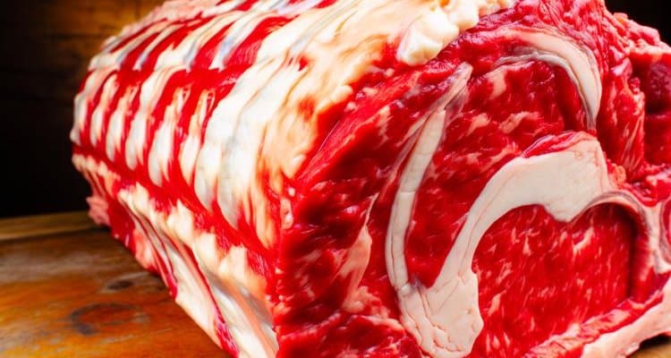 Raw prime rib roast showing quality marbling and bright red color ideal for smoking
