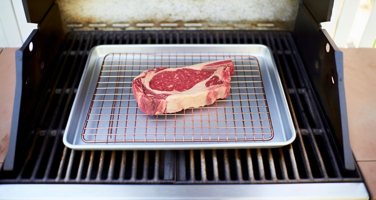 Steak on wire rack during low-heat phase of reverse searing in oven