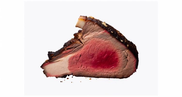 Cross-section of smoked prime rib showing perfect medium-rare center and smoke ring