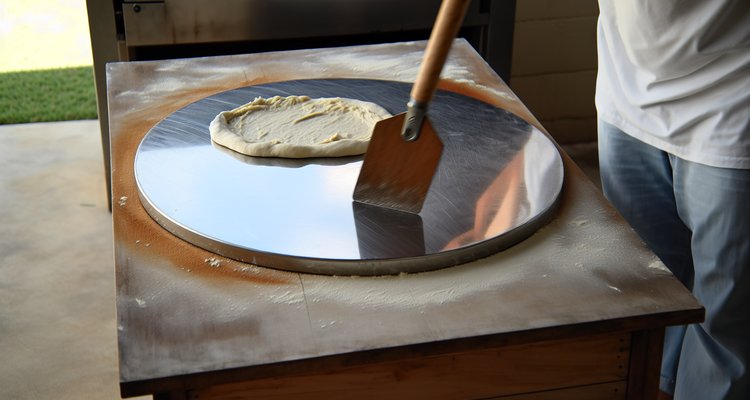Steel baking surface with pizza sliding onto it equipment review