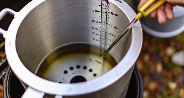 Turkey fryer pot with visible measurement markings and oil level indicator