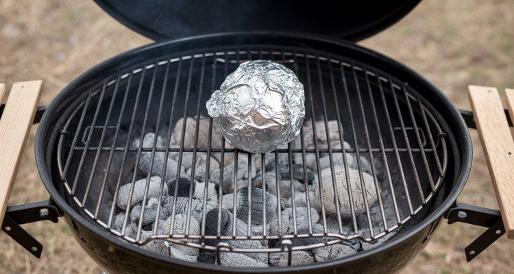 Aluminum foil ball on charcoal grill grates for safe grate cleaning