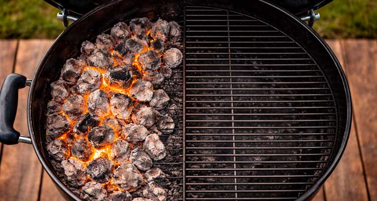 Open kettle grill showing two-zone arrangement.