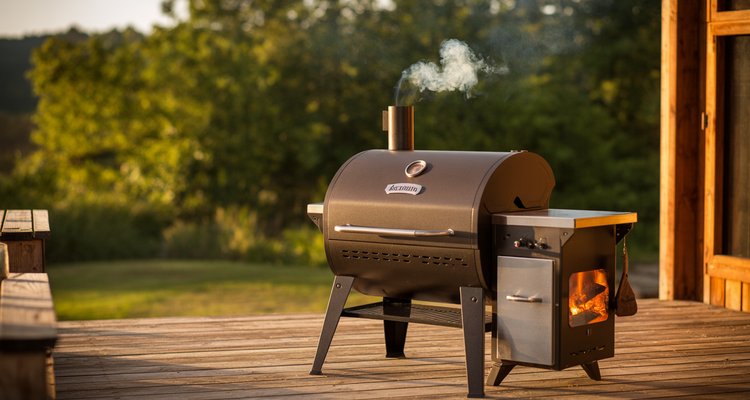 Best Traeger grills - bronze wood pellet grill on backyard deck with smoke rising