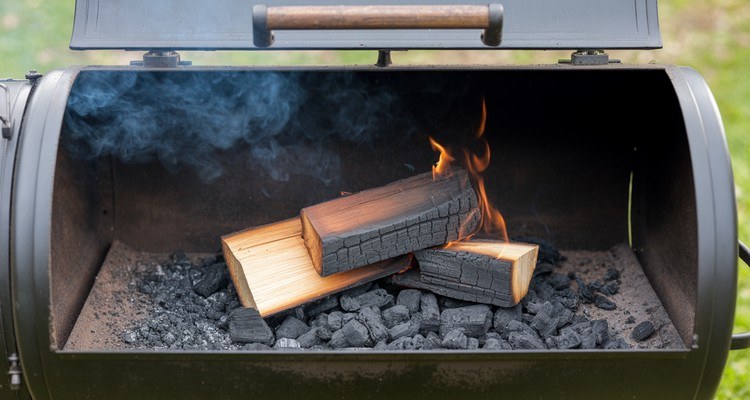 Clean offset smoker fire with hot coals, burning wood, and visible flame