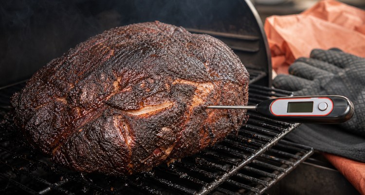Temperature probe checking a smoked pork shoulder before resting
